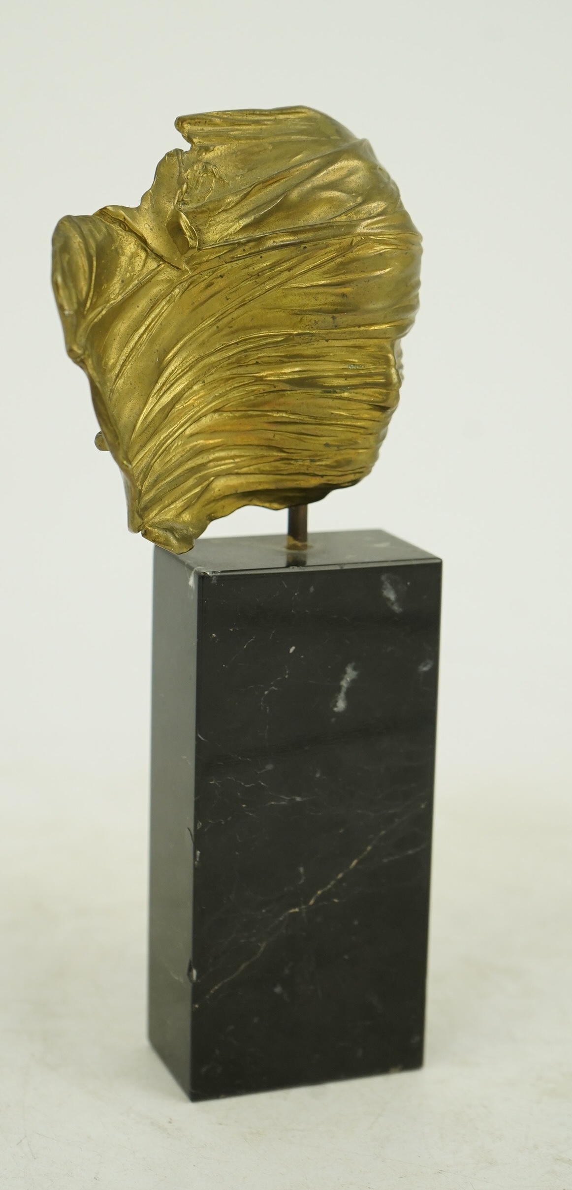 Igor Mitoraj (Polish, 1944-2014), Visage Envolé, bronze and black marble, 16.5 x 7 x 2.5cm